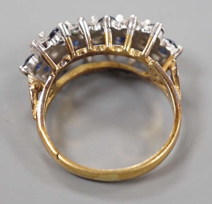 A modern 18ct, sapphire and diamond cluster set half hoop ring, size K, gross weight 5.1 grams.